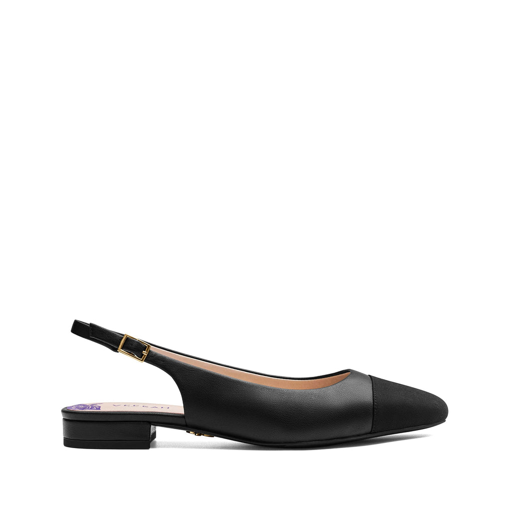 Black vegan slingback flats with an almond shaped cap toe in grosgrain ribbon, low heel, and gold adjustable buckle. Elegant and versatile women's vegan shoes.
