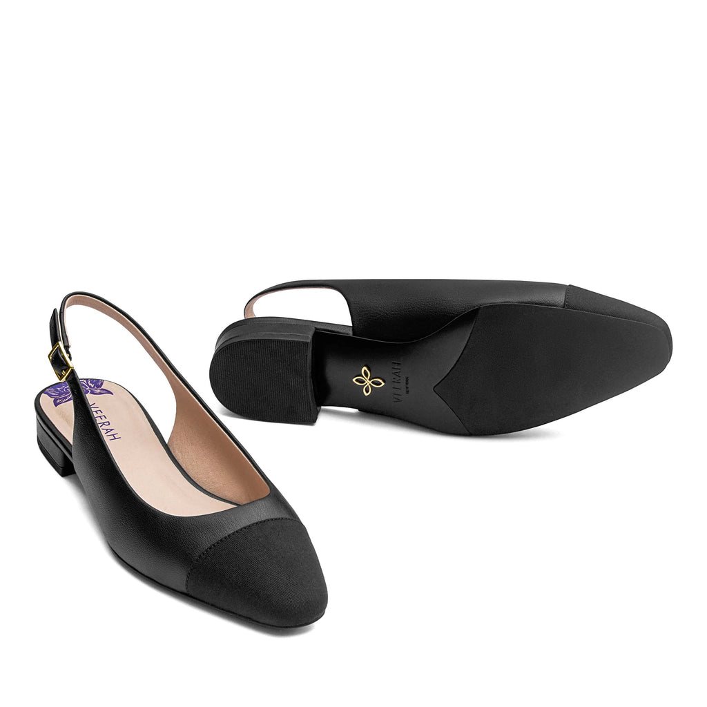 Black vegan slingback flats with a pointed cap toe in grosgrain ribbon, low heel, and gold adjustable buckle. Elegant and versatile women's vegan shoes.
