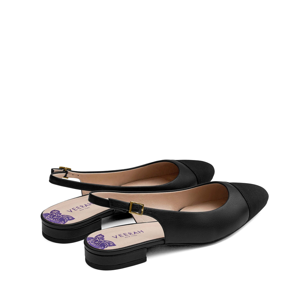 Black vegan slingback flats with a pointed cap toe in grosgrain ribbon, low heel, and gold adjustable buckle. Elegant and versatile women's vegan shoes.