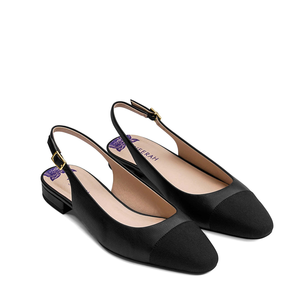 Black vegan slingback flats with an almond shaped cap toe in grosgrain ribbon, low heel, and gold adjustable buckle. Elegant and versatile women's vegan shoes.