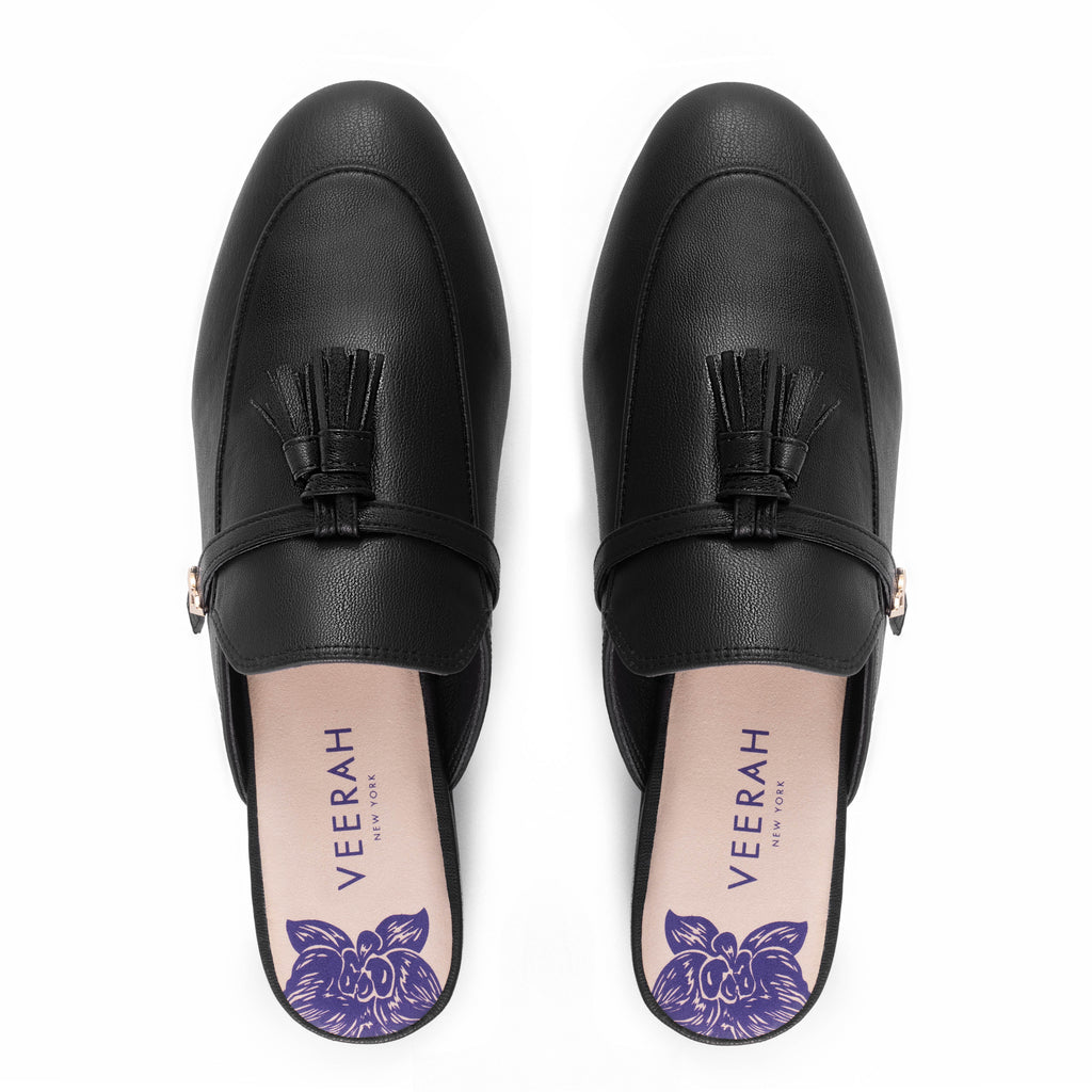 Black vegan apple leather loafer style slip-on mules by Veerah with a minimalist design and floral insole detail