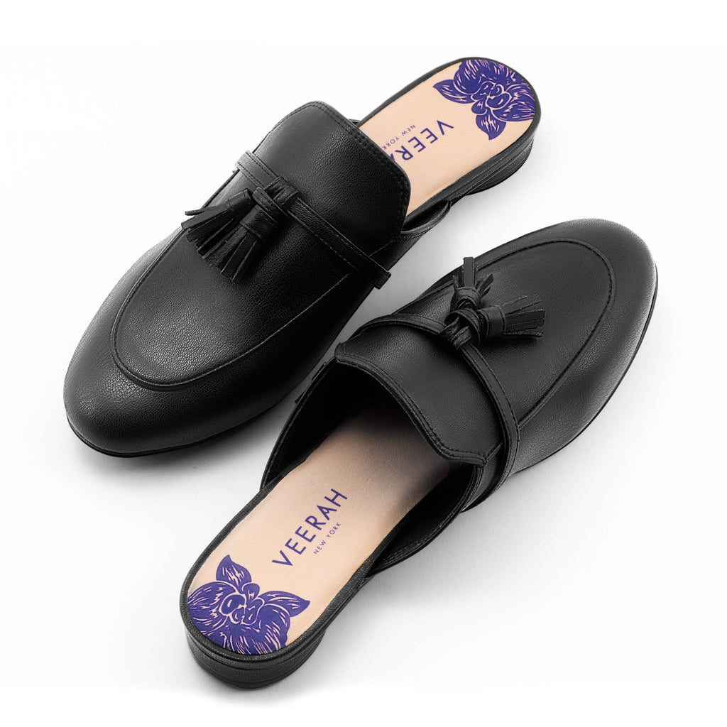 Black vegan apple leather loafer style slip-on mules by Veerah with a minimalist design and floral insole detail