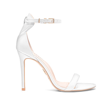 White high-heeled vegan sandals, featuring a minimalist ankle strap design and stiletto heel - stylish women's vegan shoe for an elegant bridal and special occasion look.