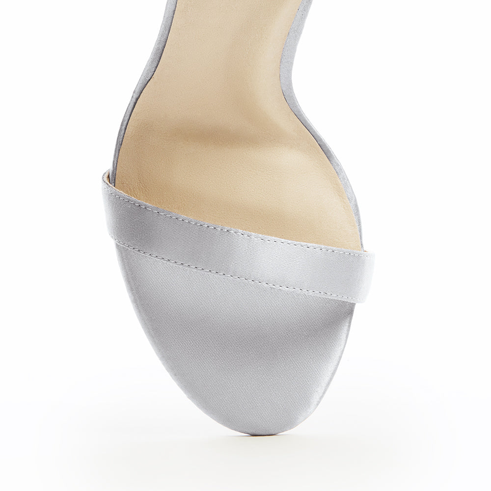 Elegant black high-heeled vegan silk sandal, featuring a minimalist ankle strap, and open-toe design, perfect for sophisticated and stylish occasions.
